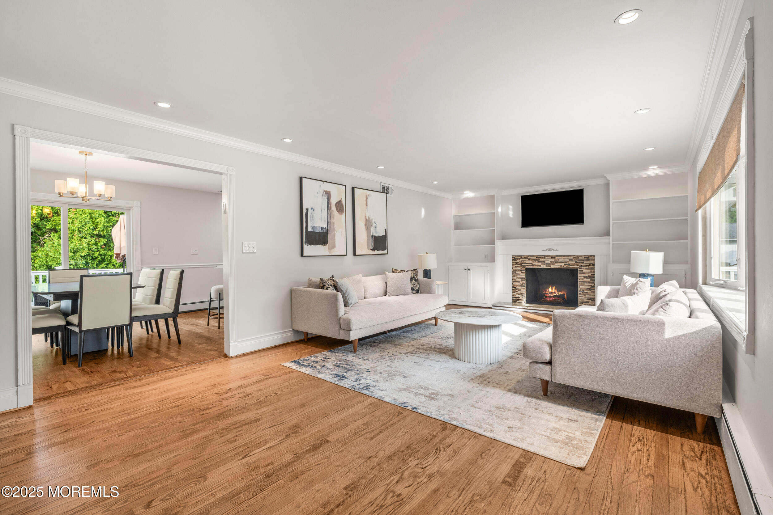 351 Hollywood Avenue Long Branch, NJ 07740 - Photo 3 of 34 a living room with furniture a fireplace and a flat screen tv