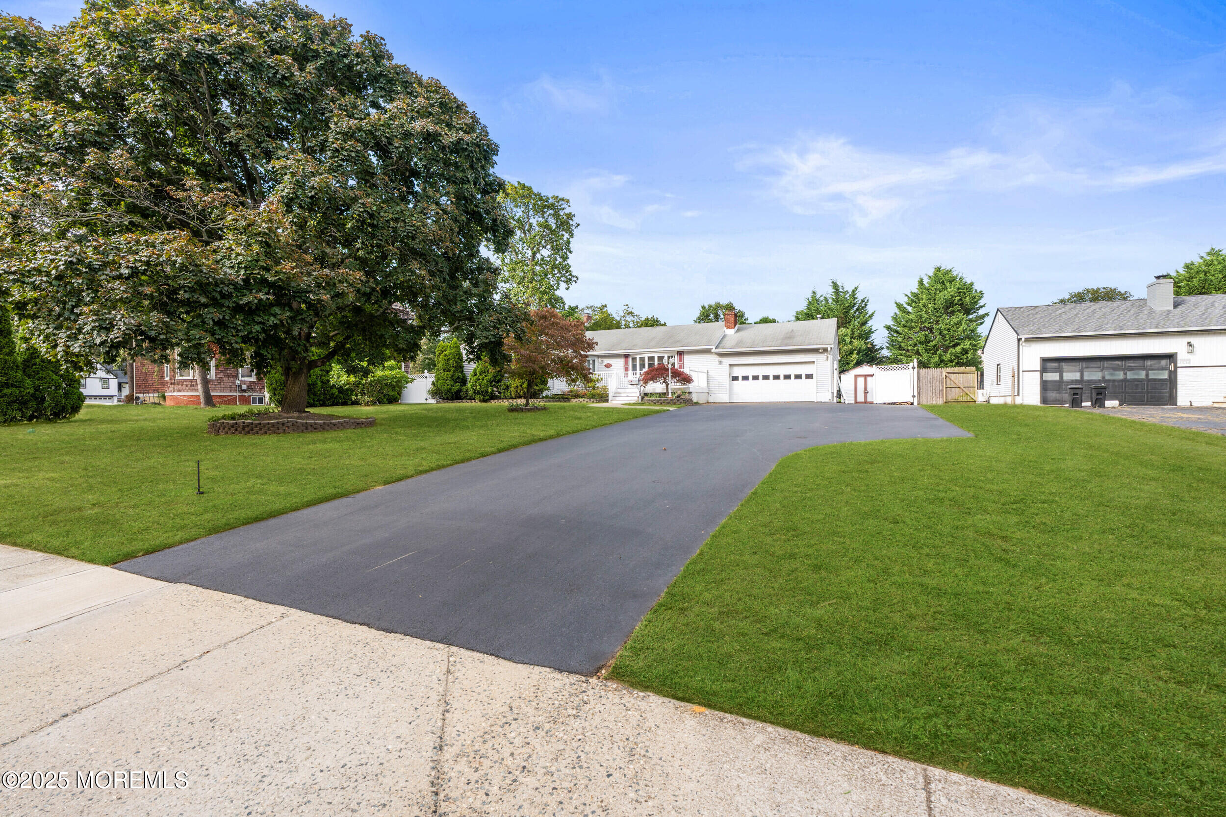351 Hollywood Avenue Long Branch, NJ 07740 - Photo 31 of 34 a view of a street with a big yard and a large trees