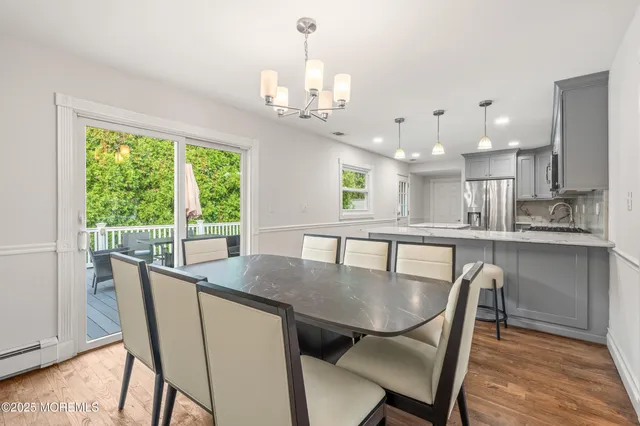 a dining room with furniture a window and kitchen view