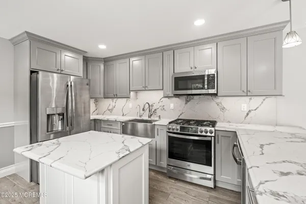 a kitchen with a stove a refrigerator and a microwave