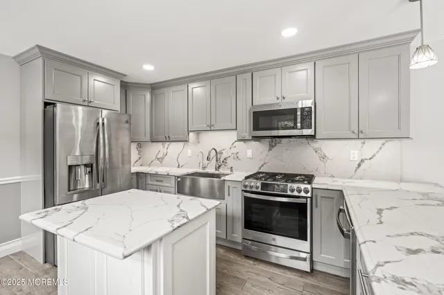 a kitchen with a stove a refrigerator and a microwave
