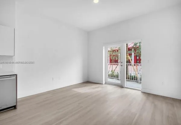 a view of an empty room with painting on the wall