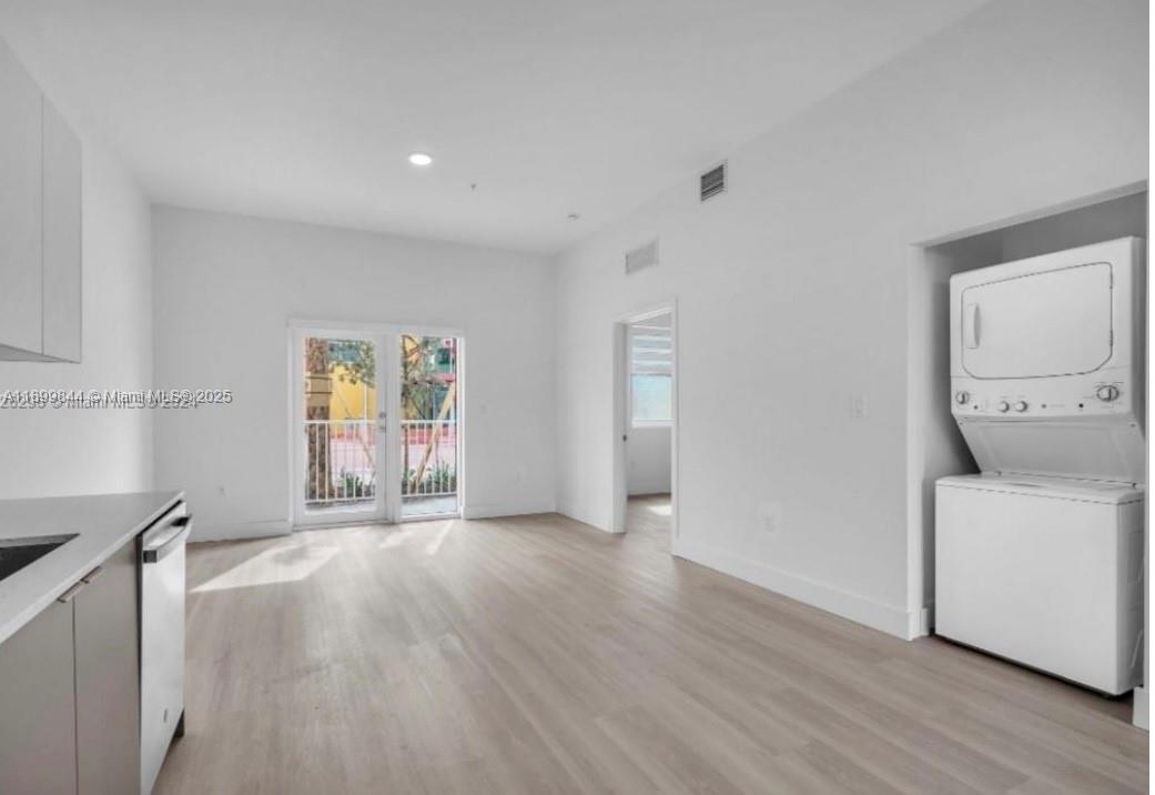 110 Foster Road, Unit 109B Hallandale Beach, FL 33009 - Photo 7 of 12 a view of an empty room with a window and wooden floor
