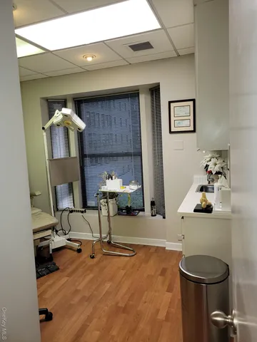 a bedroom with furniture and a wooden floor