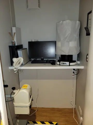 a view of a room with wooden floor and lounge chair