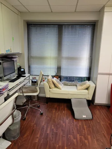 a bedroom with a bed and teddy bear on bed