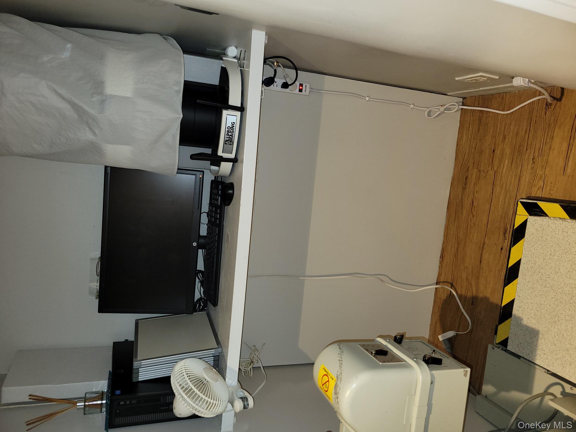 161 Madison Avenue, Unit 7SW Manhattan, NY 10016 - Photo 17 of 21 a room with gym equipment and a flat screen tv