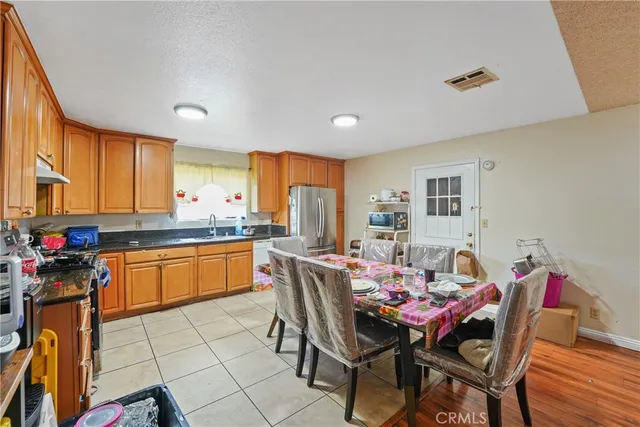 a kitchen that has a table and chairs in it