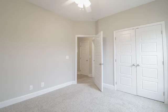 a view of an empty room and closet area