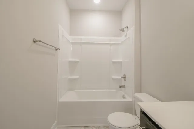 a bathroom with a toilet and bathtub