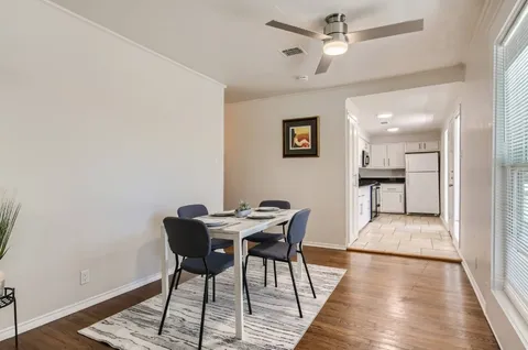 a view of a dining room with furniture and wooden floor