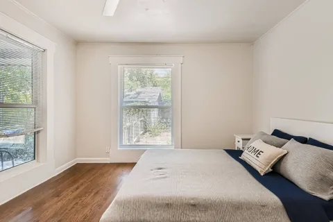 a bedroom with a bed and a window