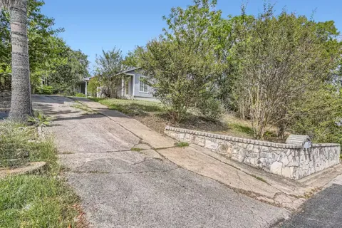 a view of a yard with large trees
