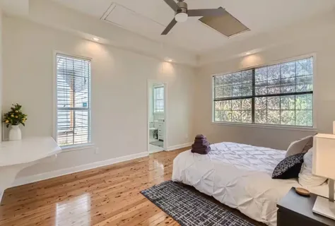 a bedroom with a large bed and a window
