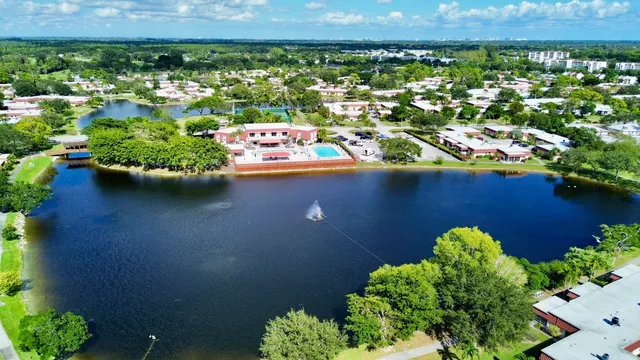 an aerial view of a house with a yard and lake view