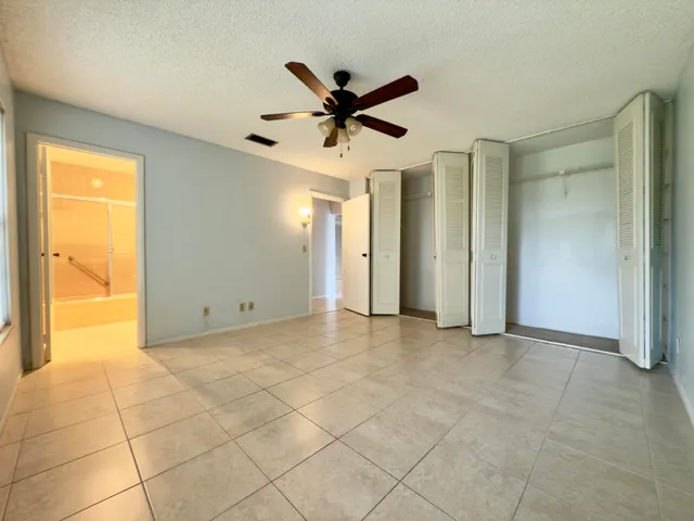 a view of a livingroom with a ceiling fan and window