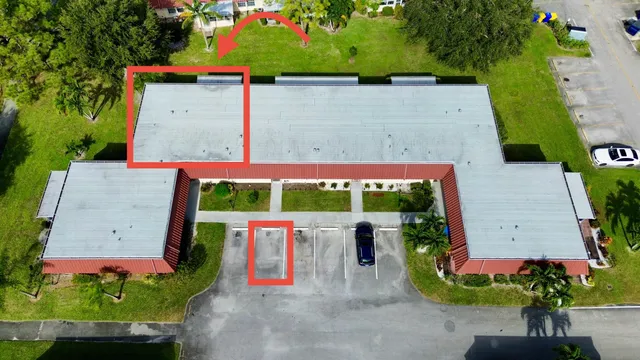 an outdoor space with seating area and trees in the background
