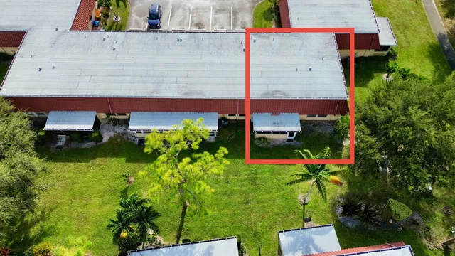 aerial view of a house with a yard and garden