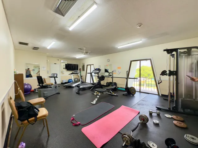 a room with gym equipment and a large window