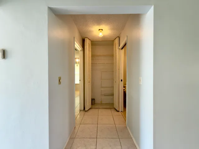 a view of a hallway with a bathroom