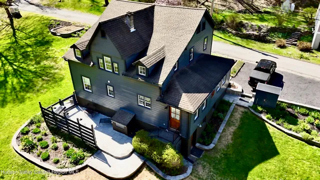 an aerial view of a house with garden space and street view