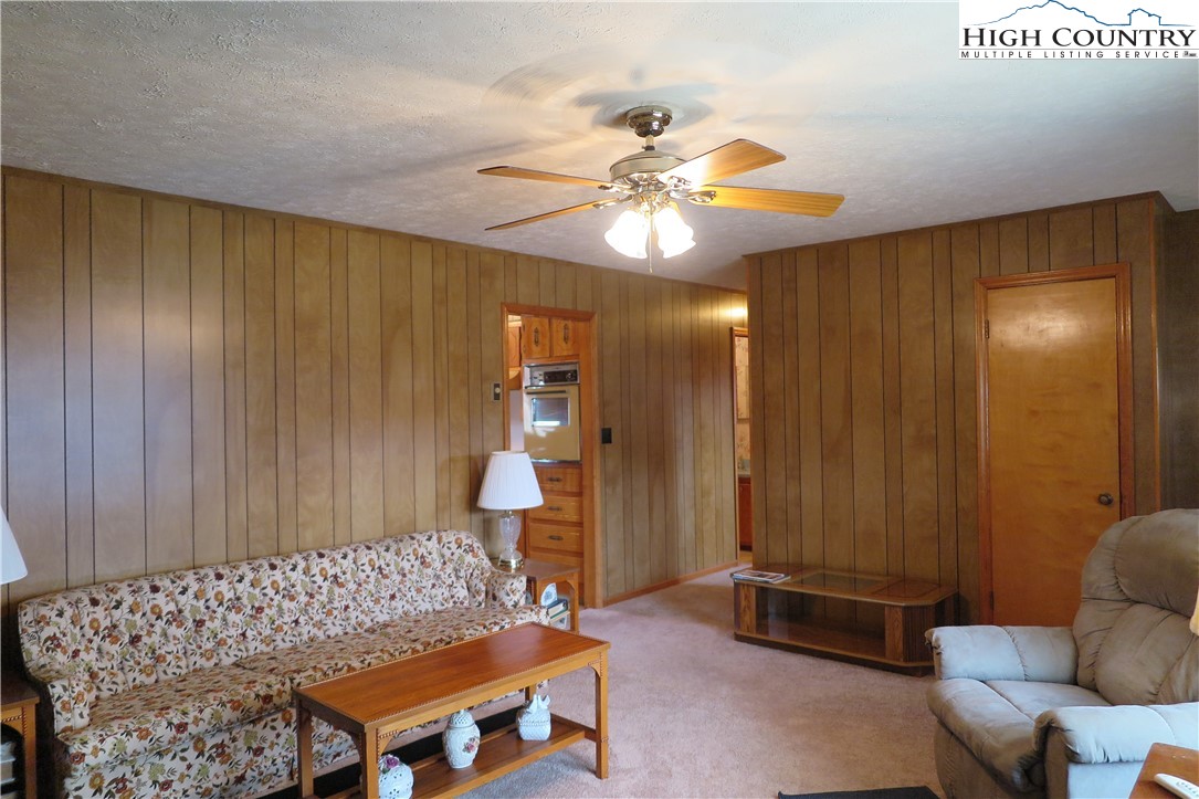 134 Carson Boulevard Sparta, NC 28675 - Photo 3 of 15 a bedroom with a bed and a chandelier