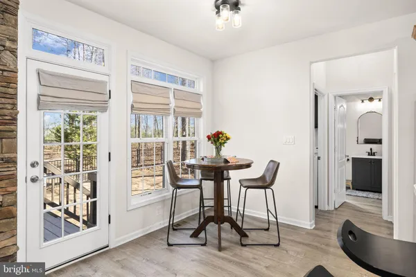 a kitchen with refrigerator a microwave a sink and cabinets