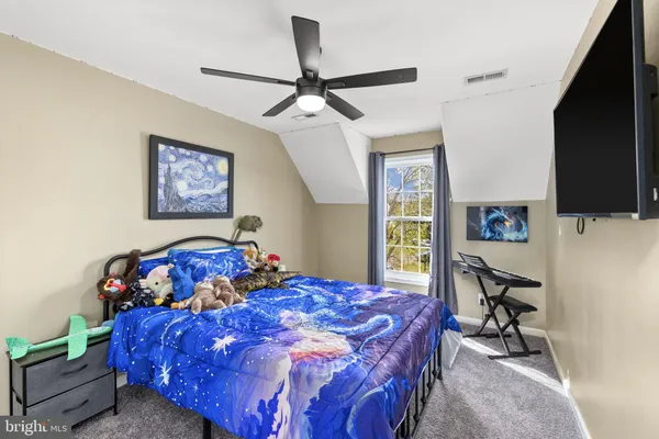 a bedroom with a bed and a television