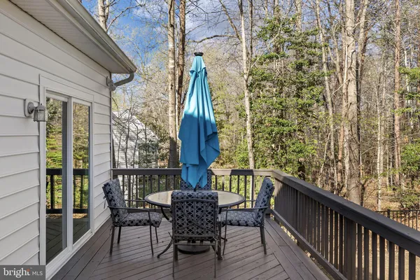 a view of a balcony with wooden floor and fence