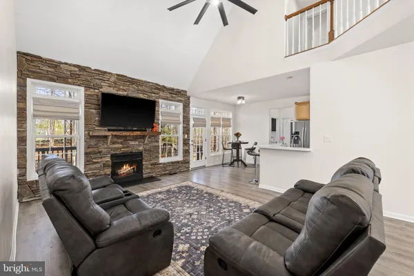 a living room with a fireplace and a flat screen tv
