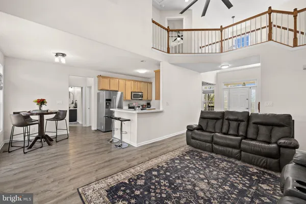 a living room with furniture ceiling fan and a rug