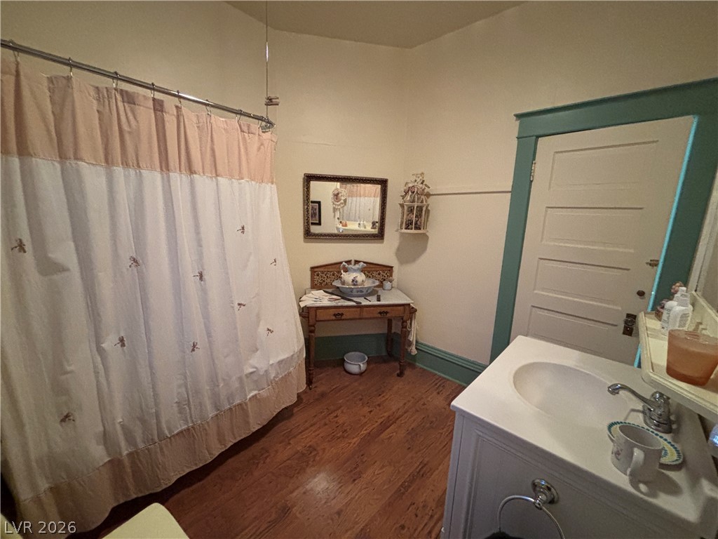 591 Campton Street Ely, NV 89301 - Photo 23 of 29 Bathroom with vanity, dark wood-style flooring, and a shower with shower curtain