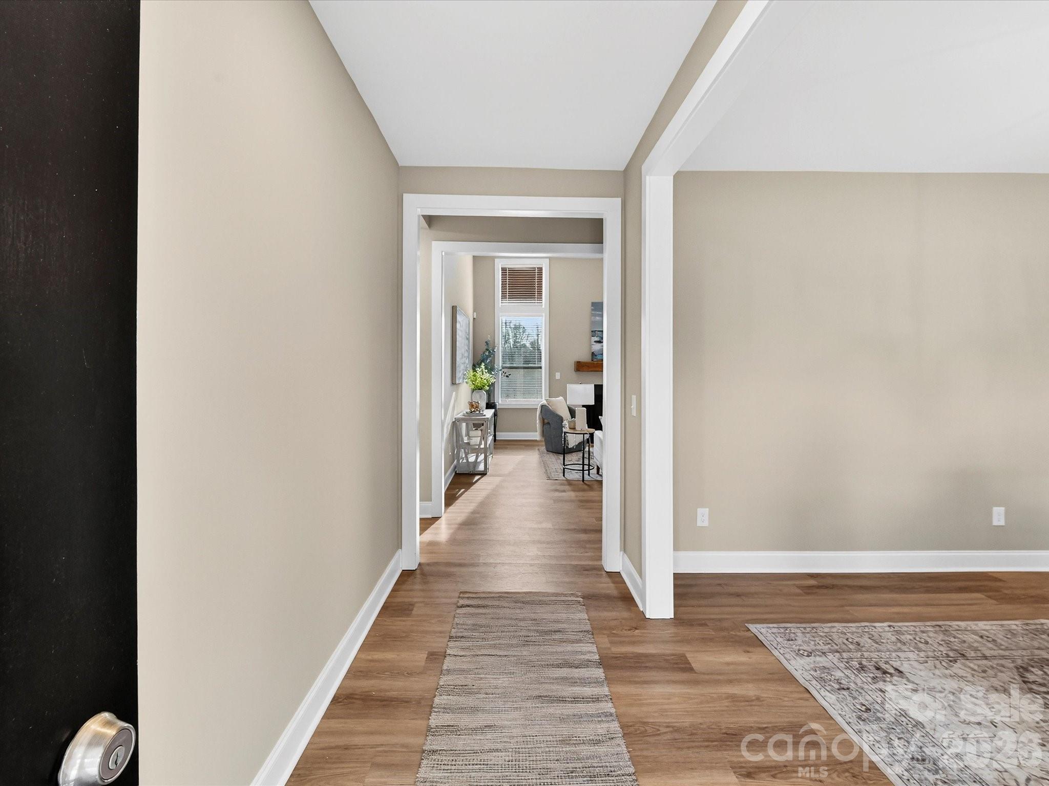 215 Lone Pine Road Statesville, NC 28625 - Photo 4 of 30 a view of a hallway with wooden floor and a living room