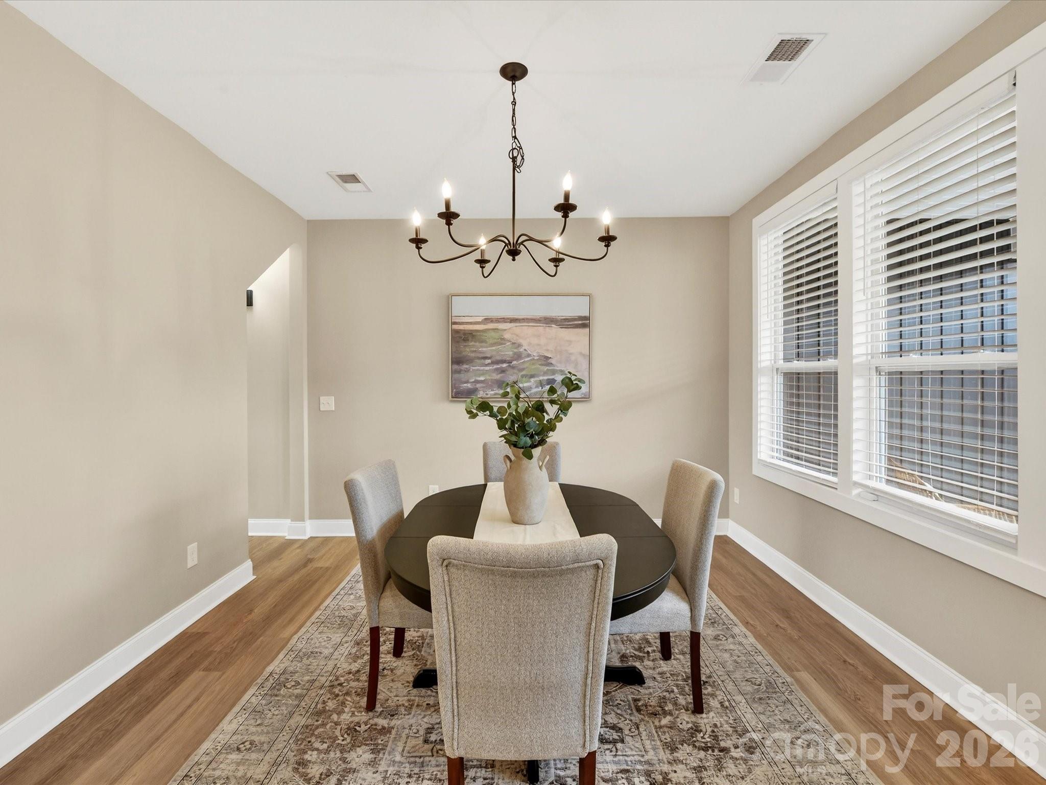 215 Lone Pine Road Statesville, NC 28625 - Photo 5 of 30 a view of a dining room with furniture a chandelier and wooden floor