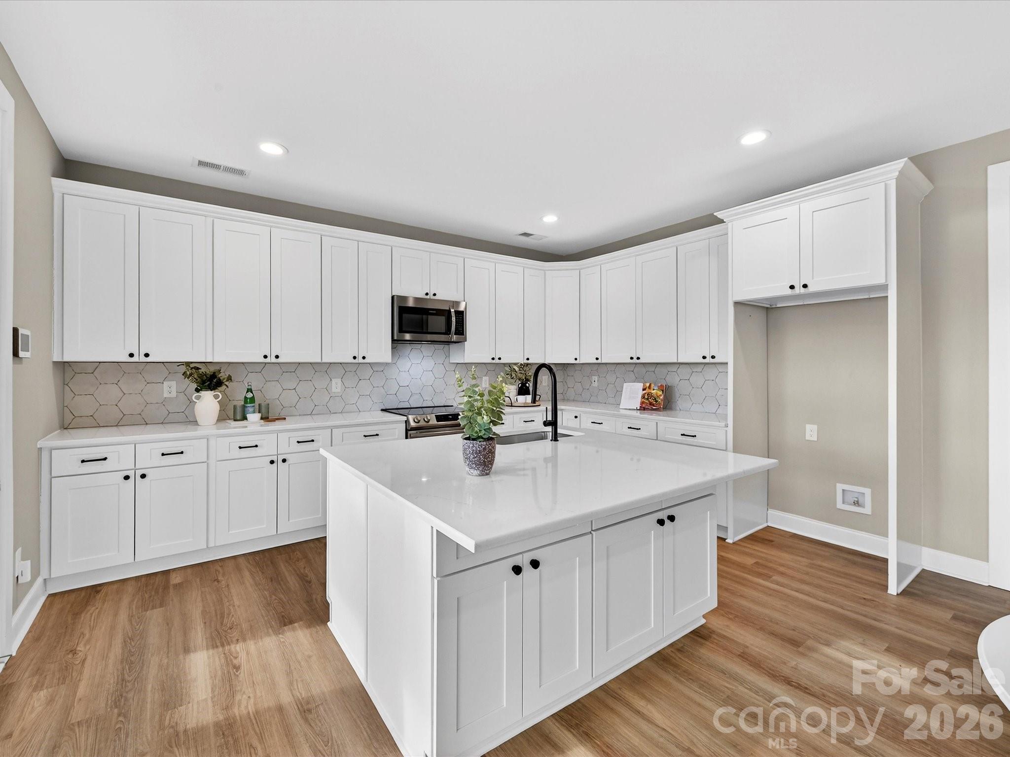 215 Lone Pine Road Statesville, NC 28625 - Photo 9 of 30 a kitchen with white cabinets appliances and sink