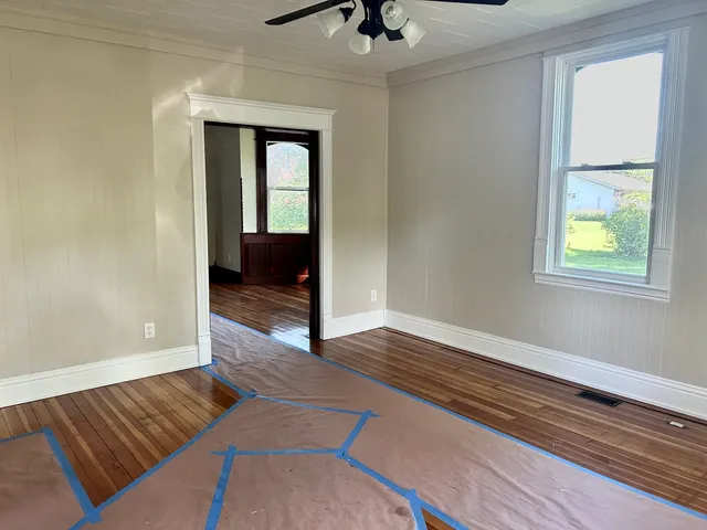 a living room with a bed and a window
