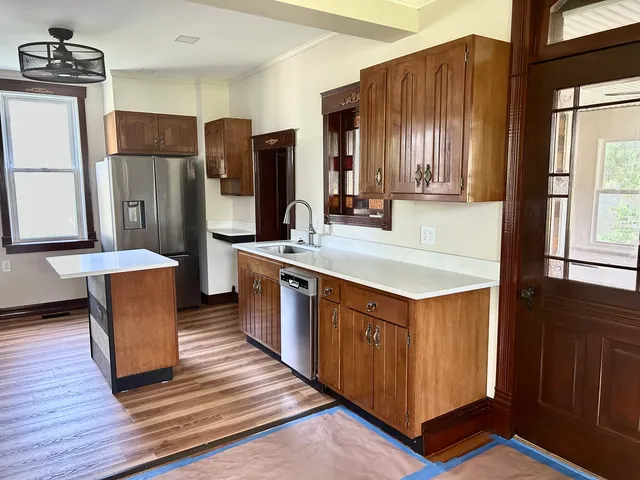 a kitchen with stainless steel appliances granite countertop a refrigerator a sink and a stove