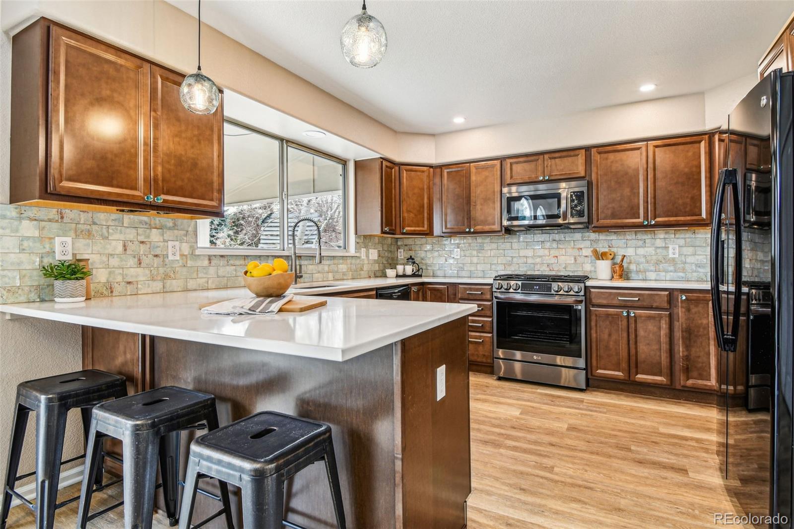 9722 Kipling Street Westminster, CO 80021 - Photo 14 of 45 a kitchen with a sink cabinets and appliances