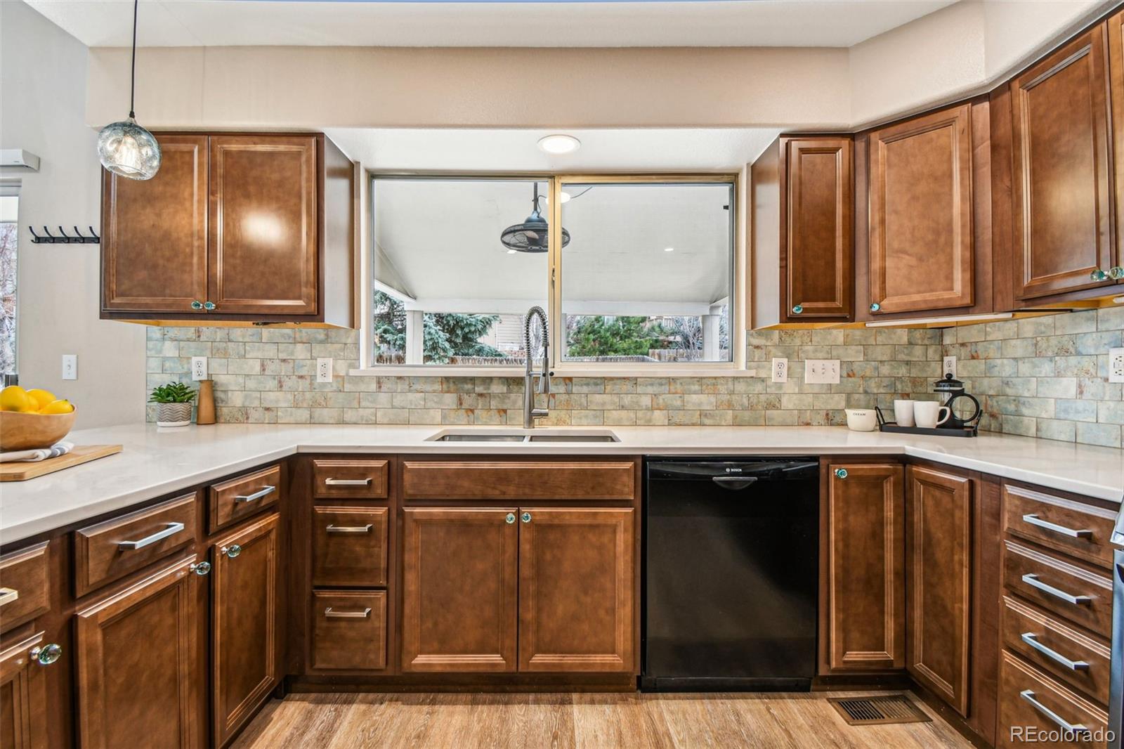 9722 Kipling Street Westminster, CO 80021 - Photo 15 of 45 a kitchen with a sink cabinets and window