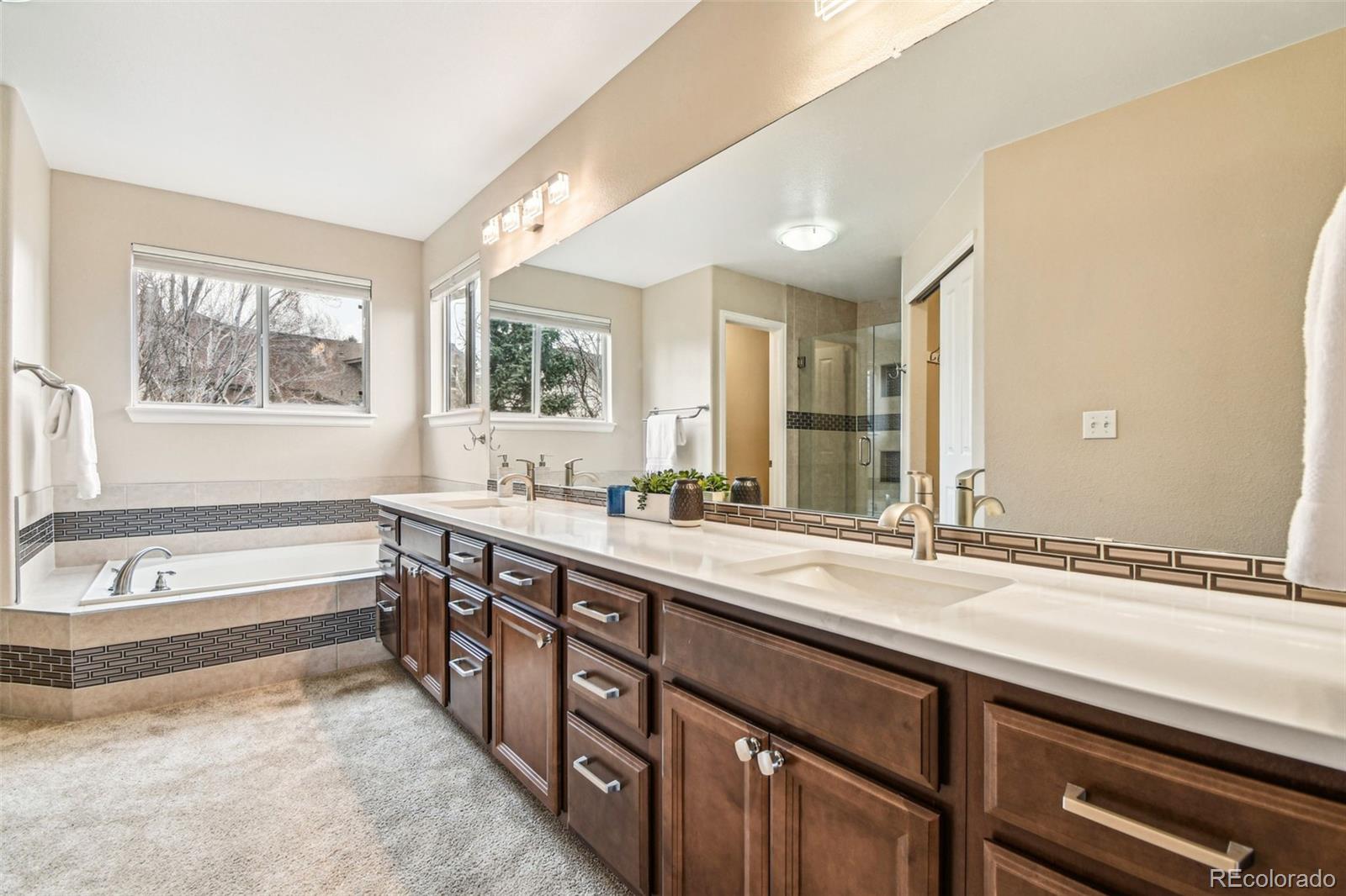 9722 Kipling Street Westminster, CO 80021 - Photo 21 of 45 a spacious bathroom with a large tub sink and mirror