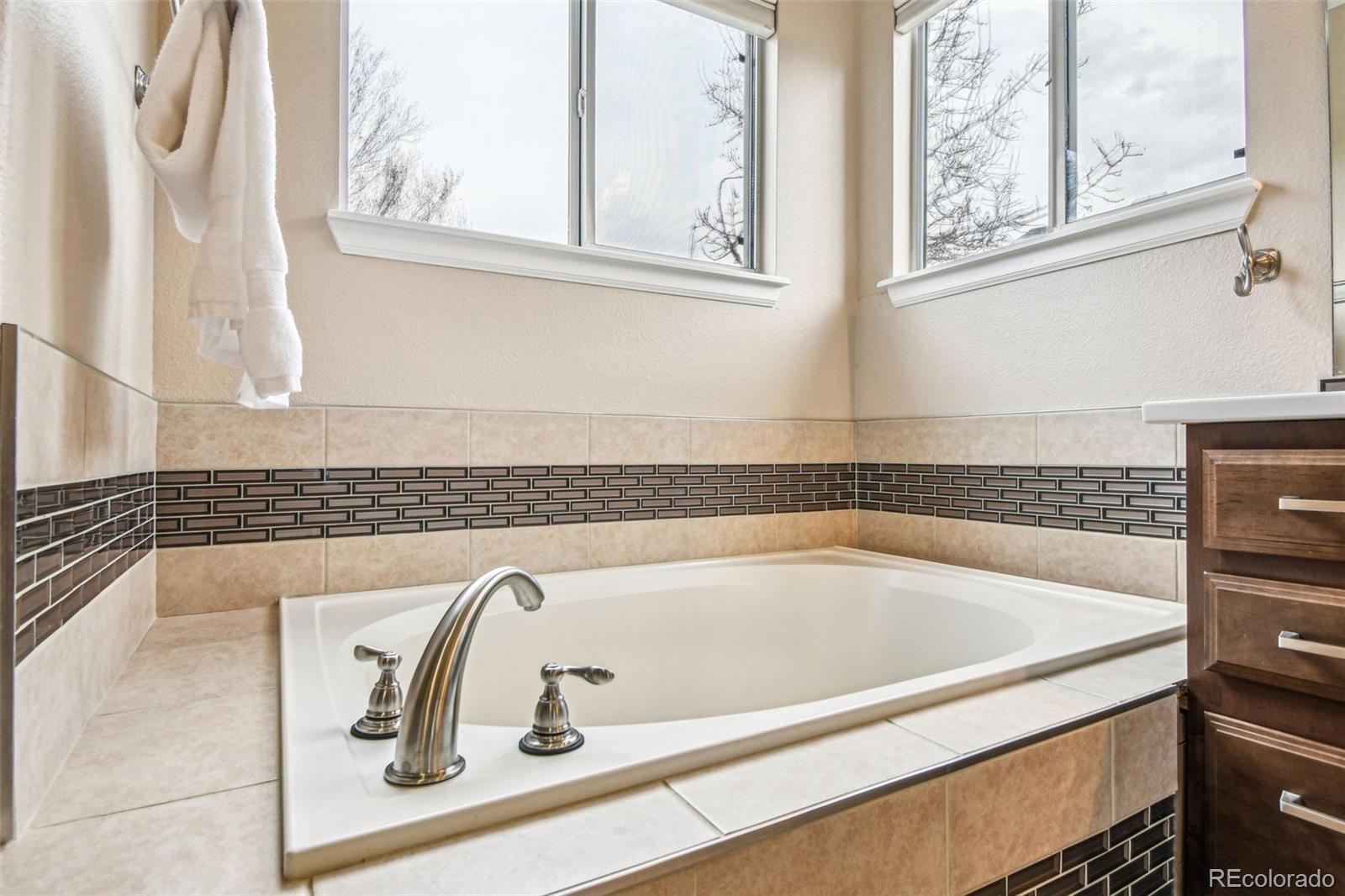 9722 Kipling Street Westminster, CO 80021 - Photo 24 of 45 a bath tub sitting next to a window