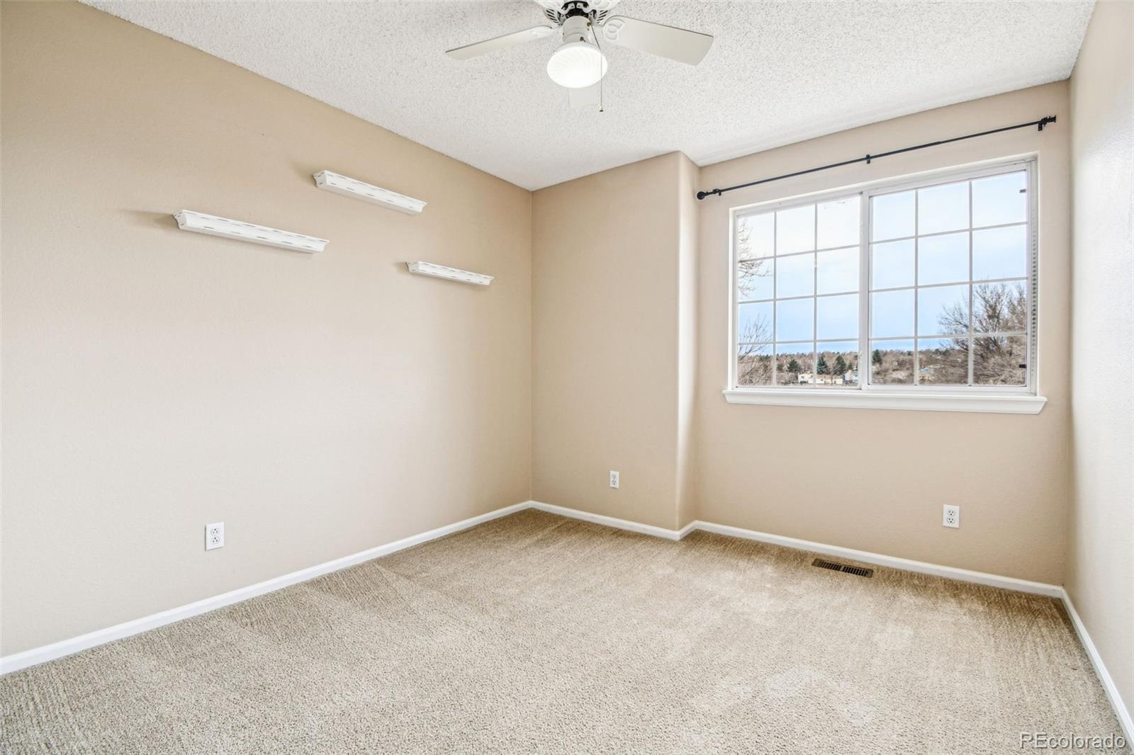 9722 Kipling Street Westminster, CO 80021 - Photo 26 of 45 an empty room with windows and fan