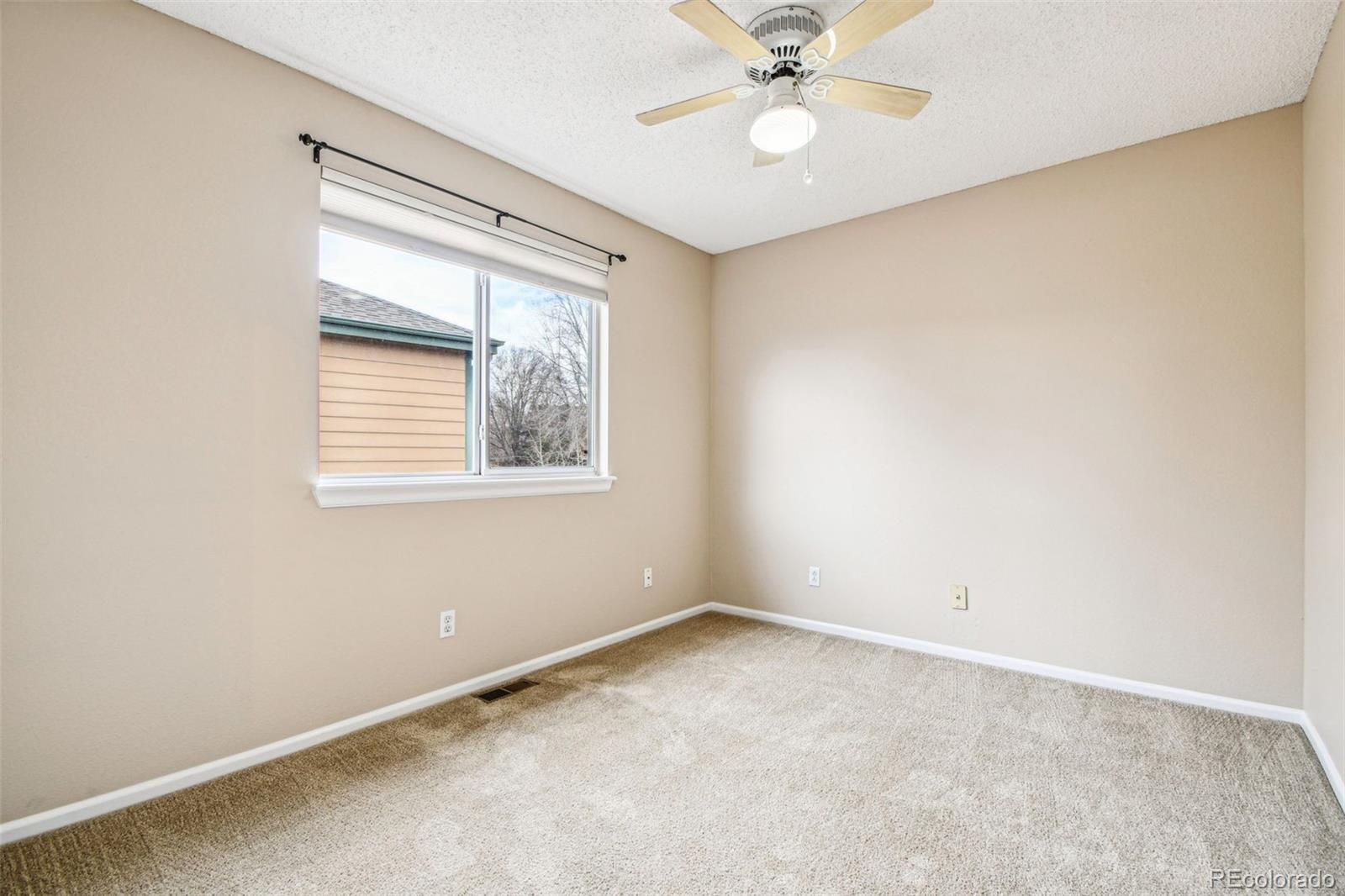 9722 Kipling Street Westminster, CO 80021 - Photo 28 of 45 an empty room with a window and a fan