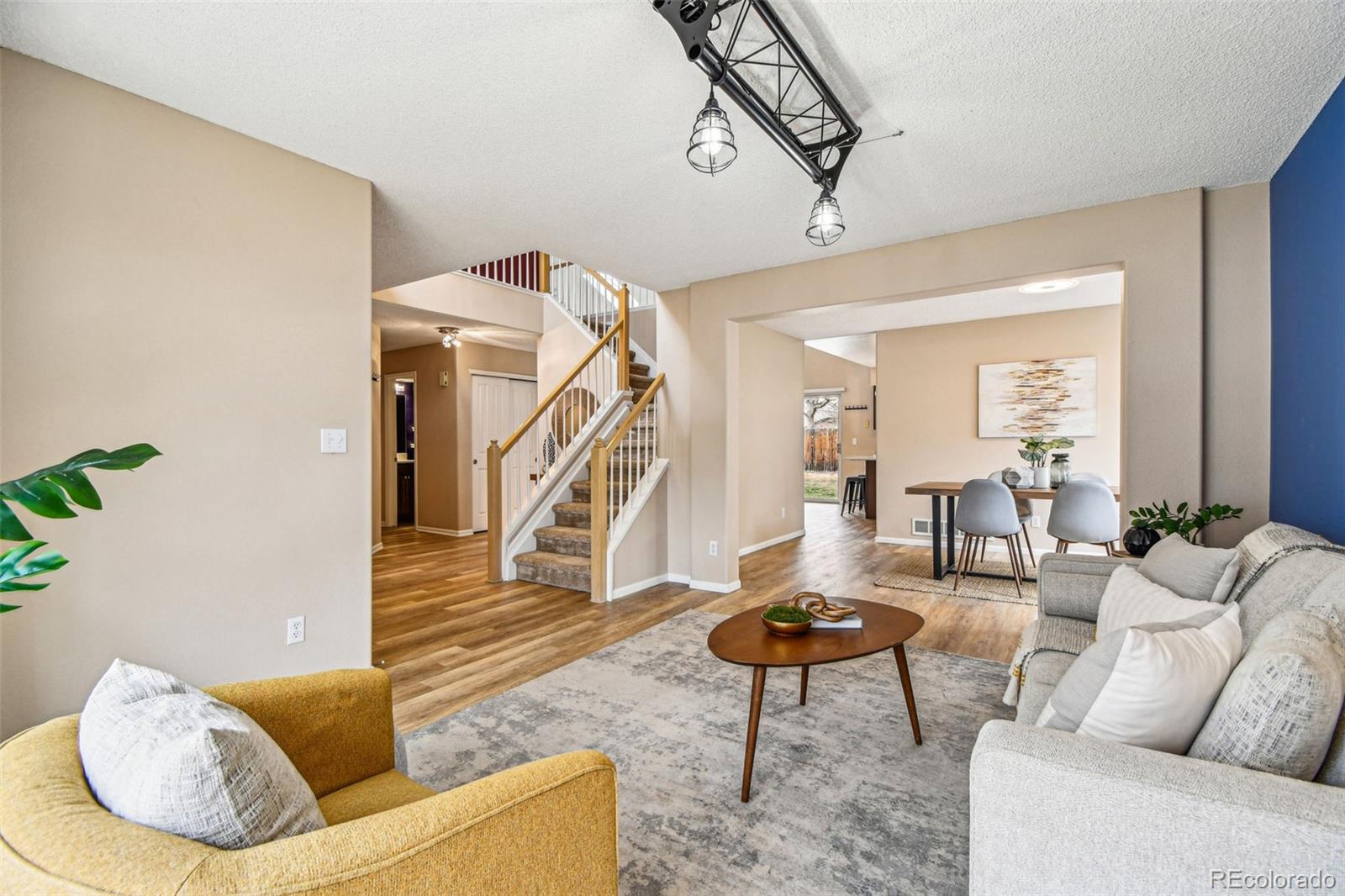 9722 Kipling Street Westminster, CO 80021 - Photo 3 of 45 a living room with couches and a dining table with kitchen view