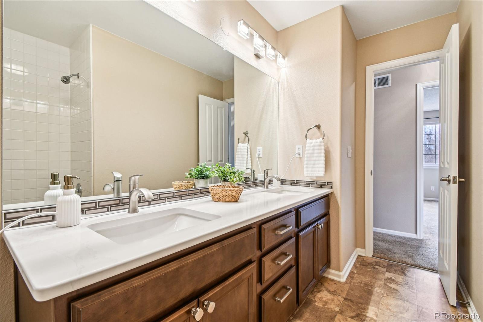 9722 Kipling Street Westminster, CO 80021 - Photo 32 of 45 a bathroom with a sink and a mirror
