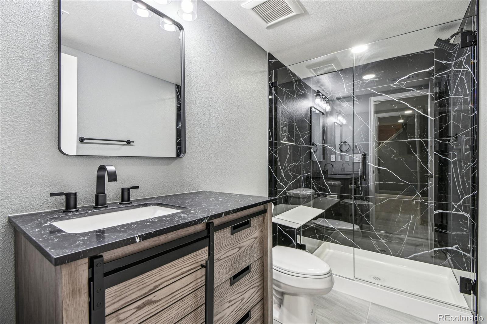 9722 Kipling Street Westminster, CO 80021 - Photo 38 of 45 a bathroom with a sink a toilet and shower