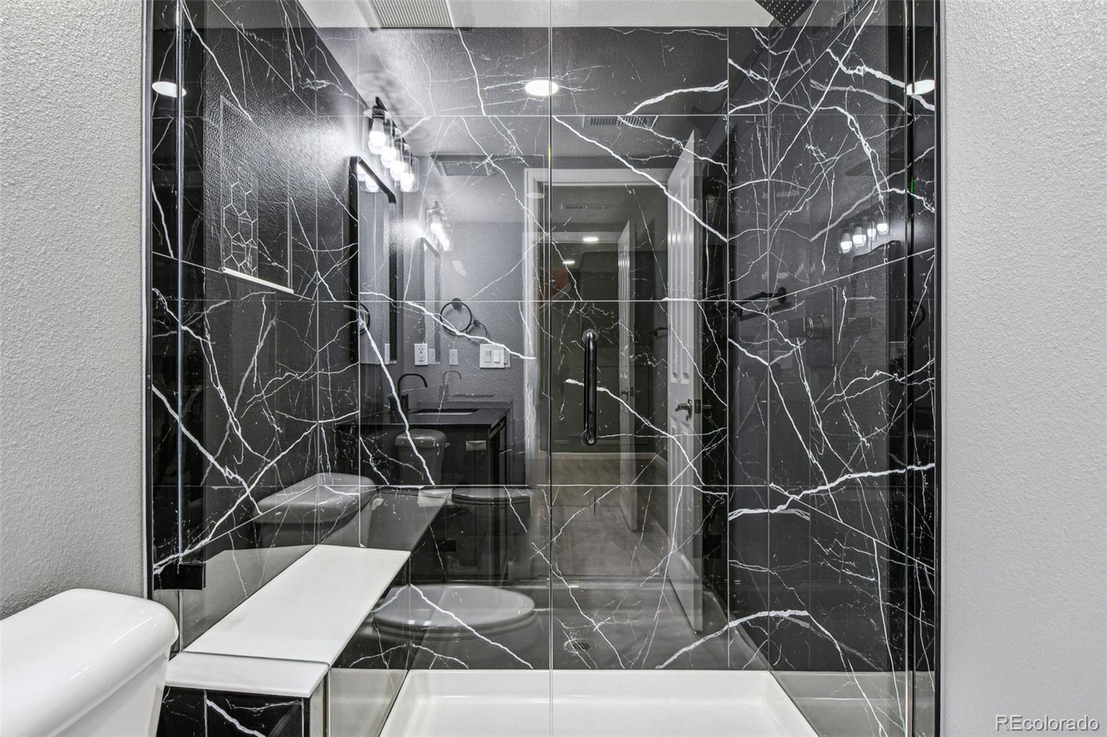 9722 Kipling Street Westminster, CO 80021 - Photo 39 of 45 a bathroom with a sink toilet and shower