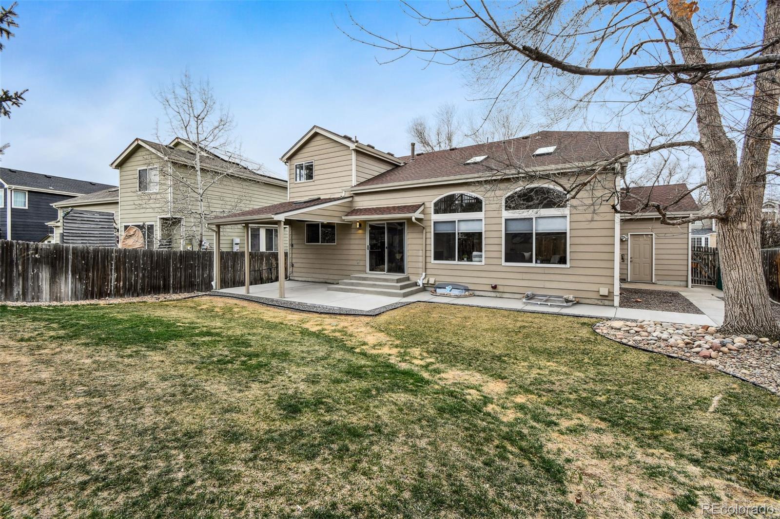 9722 Kipling Street Westminster, CO 80021 - Photo 40 of 45 a front view of a house with a garden and yard