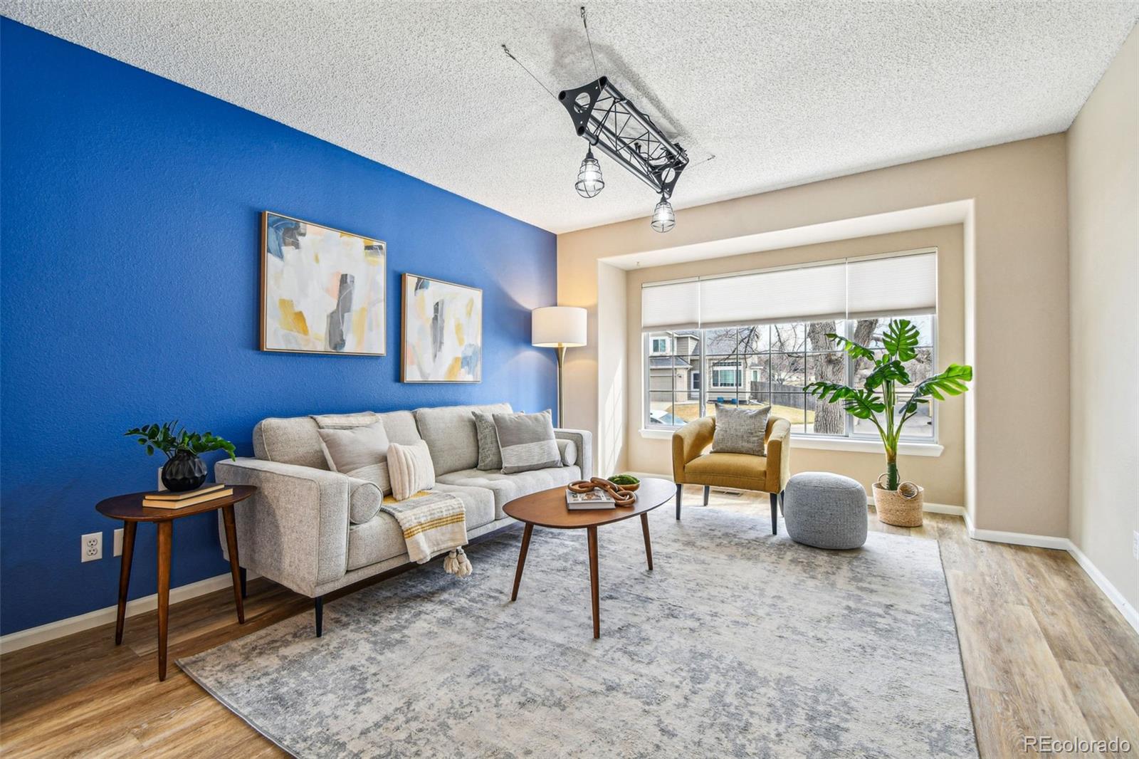 9722 Kipling Street Westminster, CO 80021 - Photo 6 of 45 a living room with furniture and a large window