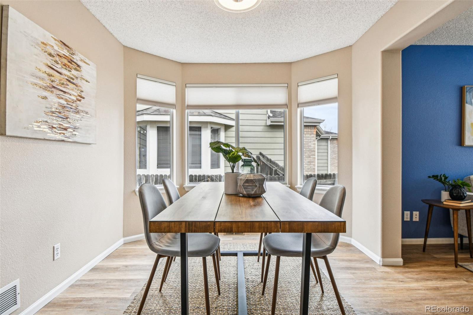 9722 Kipling Street Westminster, CO 80021 - Photo 7 of 45 a view of a dining room with furniture window and wooden floor